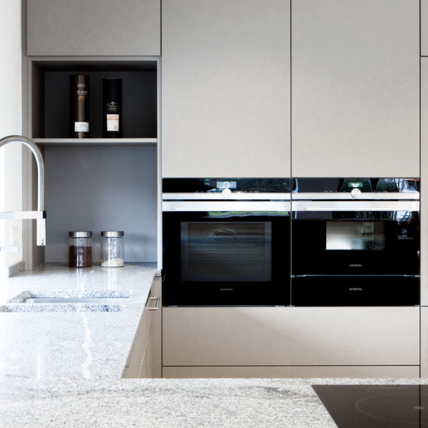 Küche in grau mit Frühstückstresen aus massivem Holz